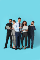 Team of young business people on blue background
