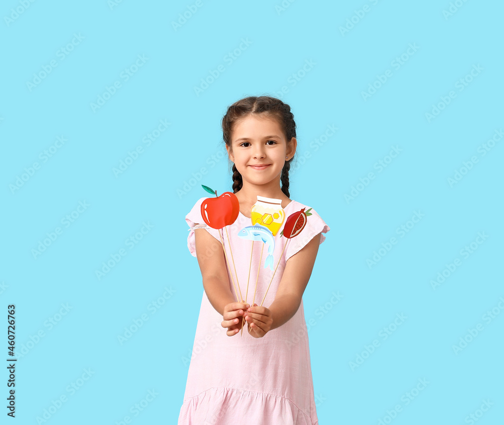 Little girl with decor for Rosh Hashanah (Jewish New Year) on color background Little girl with decor for Rosh Hashanah (Jewish New Year) on color background