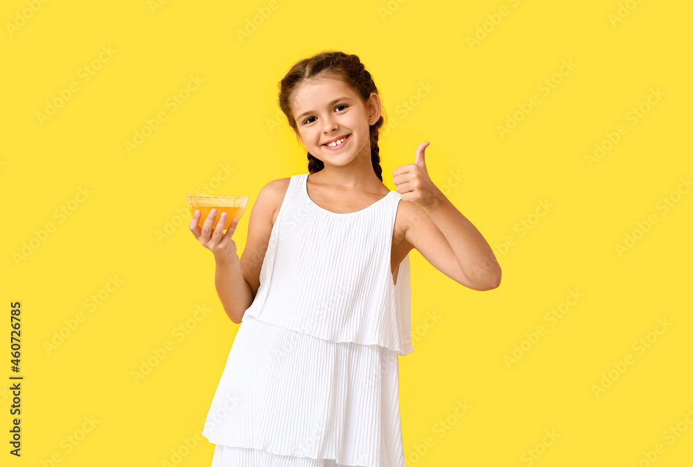 Little girl with honey showing thumb-up on color background Little girl with honey showing thumb-up on color background