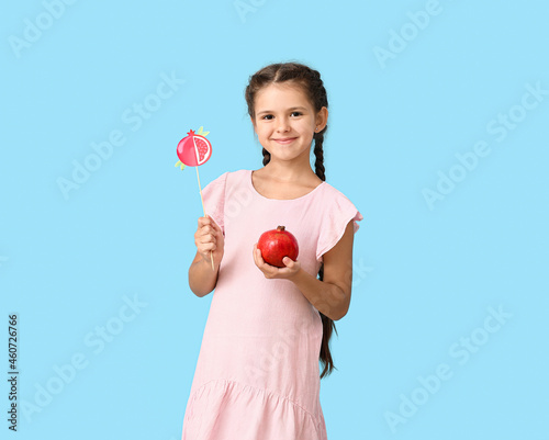 Little girl with pomegranat...