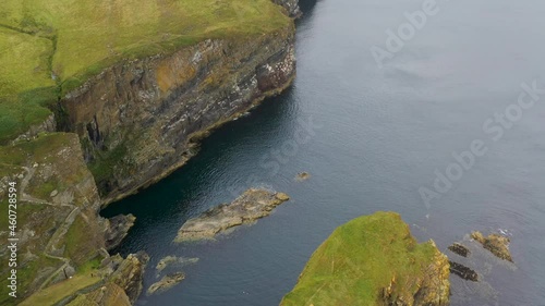 Downward angle drone shot of Whaligoe Haven and the 250ft cliffs overlooking the north sea in Scotland photo