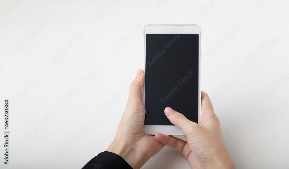 Female hand holding smartphone on white background.