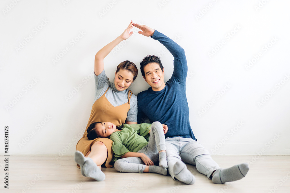 portrait enjoy happy smiling love asian family father and mother with young parents little asian girl sitting and making roof house with hands arms over head in new home portrait enjoy happy smiling love asian family father and mother with young parents little asian girl sitting and making roof house with hands arms over head in new home