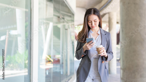 Free Download Working woman concept a young female manager attending video conference and holding a cup of coffee - GFXLoad