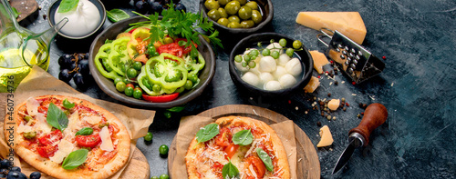 Italian food assortment on dark background.