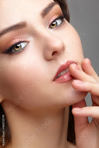 Beauty portrait of young woman. Brunette girl with evening female makeup.