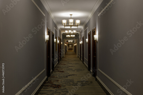 Fototapeta Empty luxurious hotel corridor lit by chandeliers in San Francisco, CA