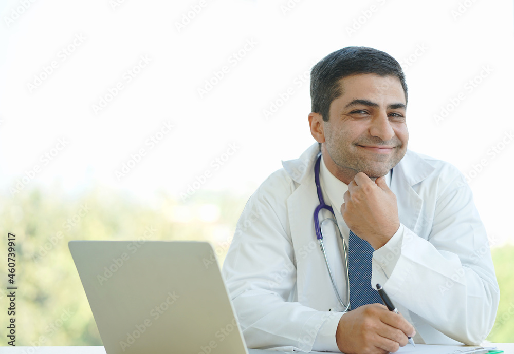 Smiling senior doctor wears white coat, and stethoscope looking at camera. Happy senior physician with smile posing for close up head shot portrait.
