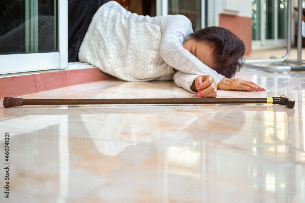 Senior woman falling down at home because stumbled on a door kerb Senior woman falling down at home because stumbled on a door kerb