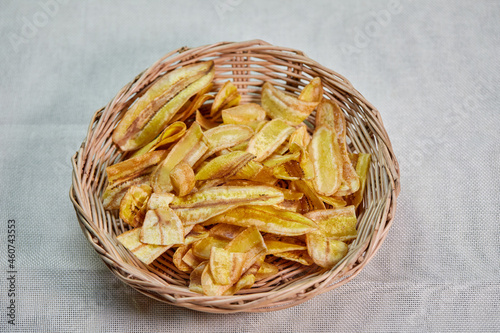 Deep fried sliced banana chips in wicker basket