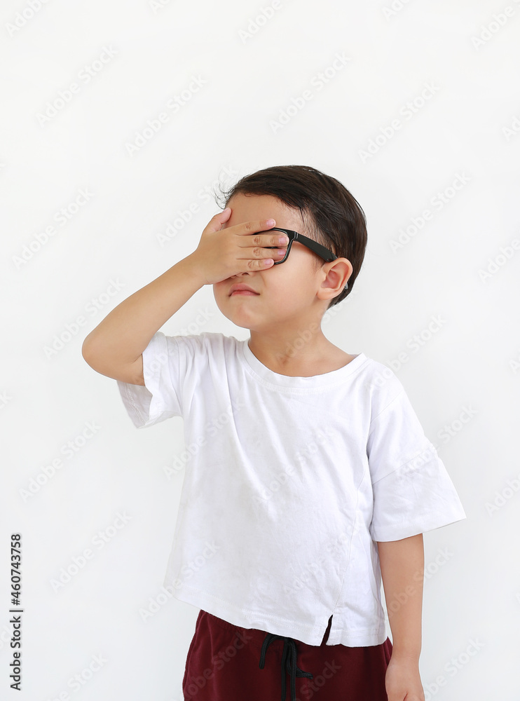 Portrait of Asian little boy child wearing glasses and closing hid eyes by one hand isolated on white background Portrait of Asian little boy child wearing glasses and closing hid eyes by one hand isolated on white background