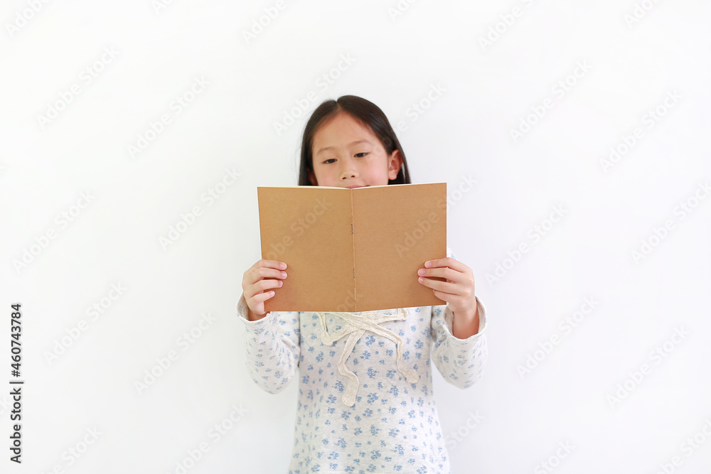 Asian little girl child holding brown book and reading over white background. Asian little girl child holding brown book and reading over white background.
