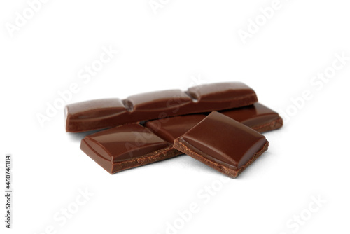 Milk chocolate pieces isolated on white background.