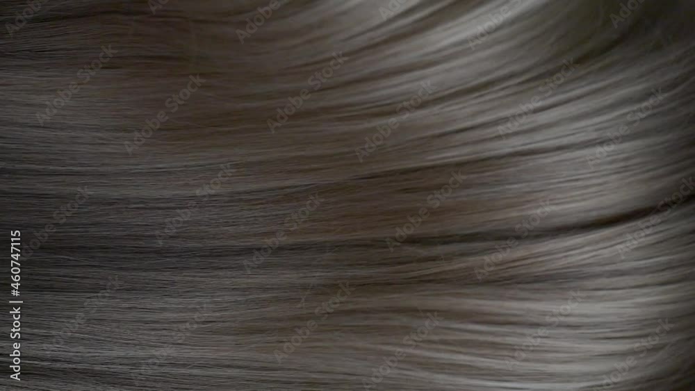 Slow motion waves of beautiful long smooth grey hair texture, haircare concept Slow motion waves of beautiful long smooth grey hair texture, haircare concept