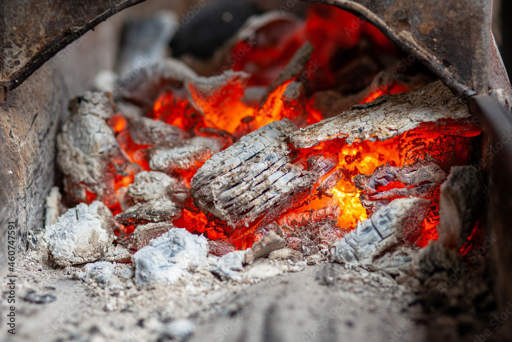 Burning coals in a metal grill for frying meat and vegetables. Cooking on a campfire. Burning coals in a metal grill for frying meat and vegetables. Cooking on a campfire.