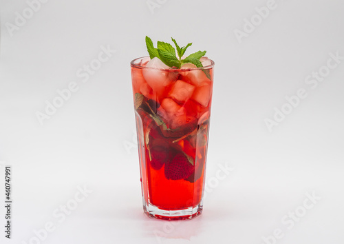 Summer Berry fruit iced tea with ice cubes against white background.