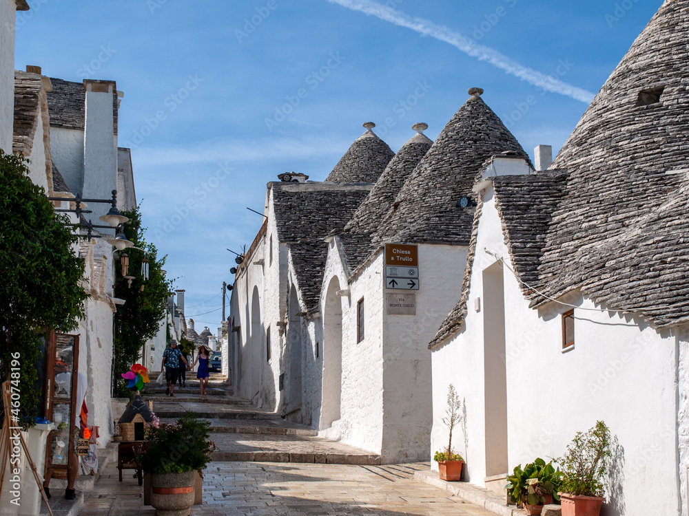 People visit Trulli village in Alberobello, Italy. The style of construction is specific to the Murge area of the Italian region of Apulia (in Italian Puglia). Made of limestone and keystone.
