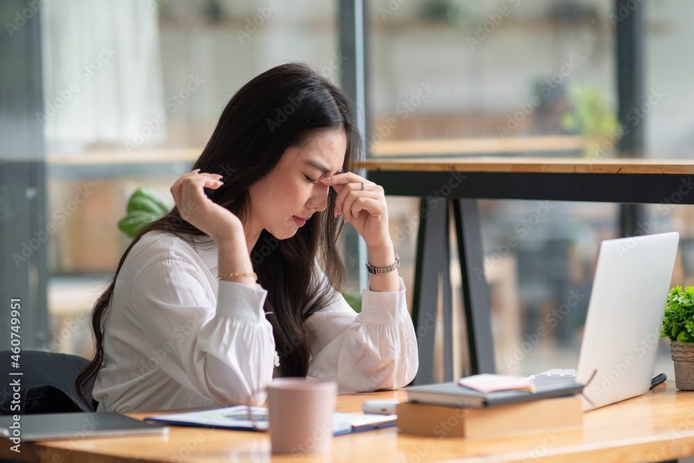 Asian businesswoman gets stressed while having a problem at work in the office. Asian businesswoman gets stressed while having a problem at work in the office.