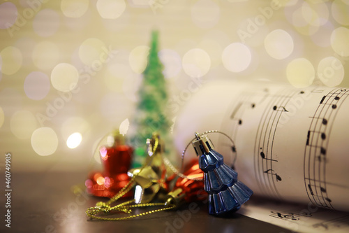 Konstfotografi Christmas decorations on music sheets, closeup