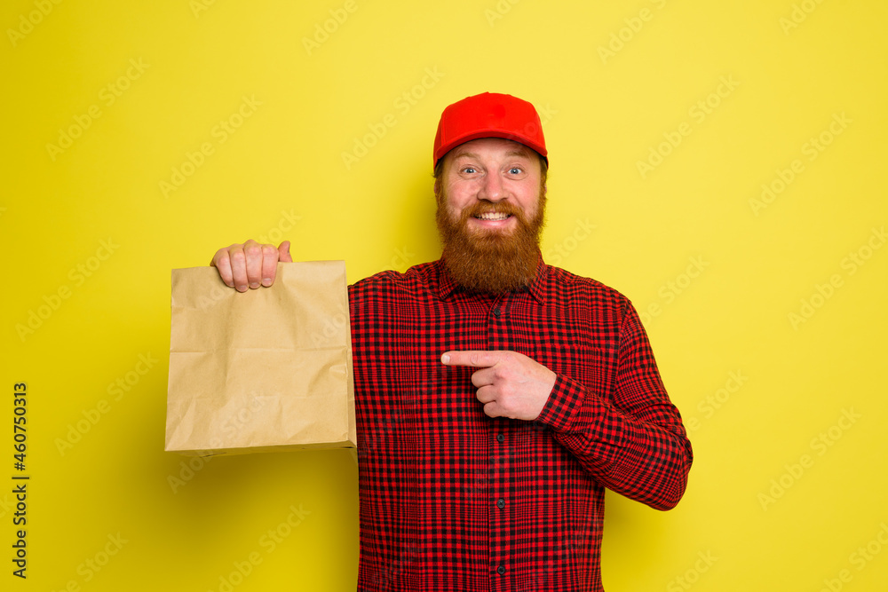 Delivery man with hat and beard has an happy expression Delivery man with hat and beard has an happy expression