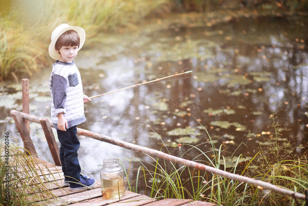 A child is fishing in the autumn morning. Autumn sunset on the pond. A fisherman with a fishing rod on the walkway. A child is fishing in the autumn morning. Autumn sunset on the pond. A fisherman with a fishing rod on the walkway.