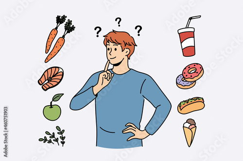 Food and diet choice concept. Young smiling man cartoon character standing trying to choose between healthy food and fat junk fast foods 