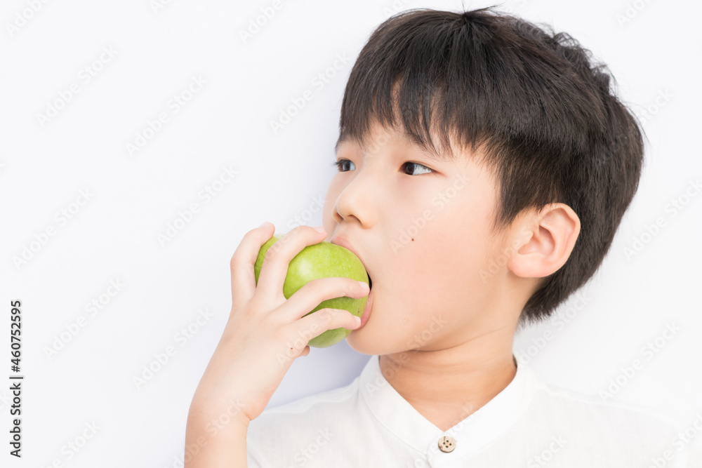 little boy holding green apple. little boy holding green apple.