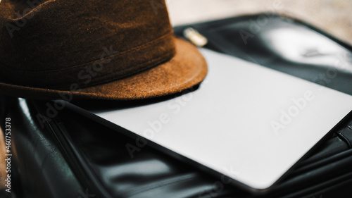 Hat on the top of a laptop.