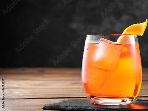 Negroni cocktail on a wooden table. Copy space.