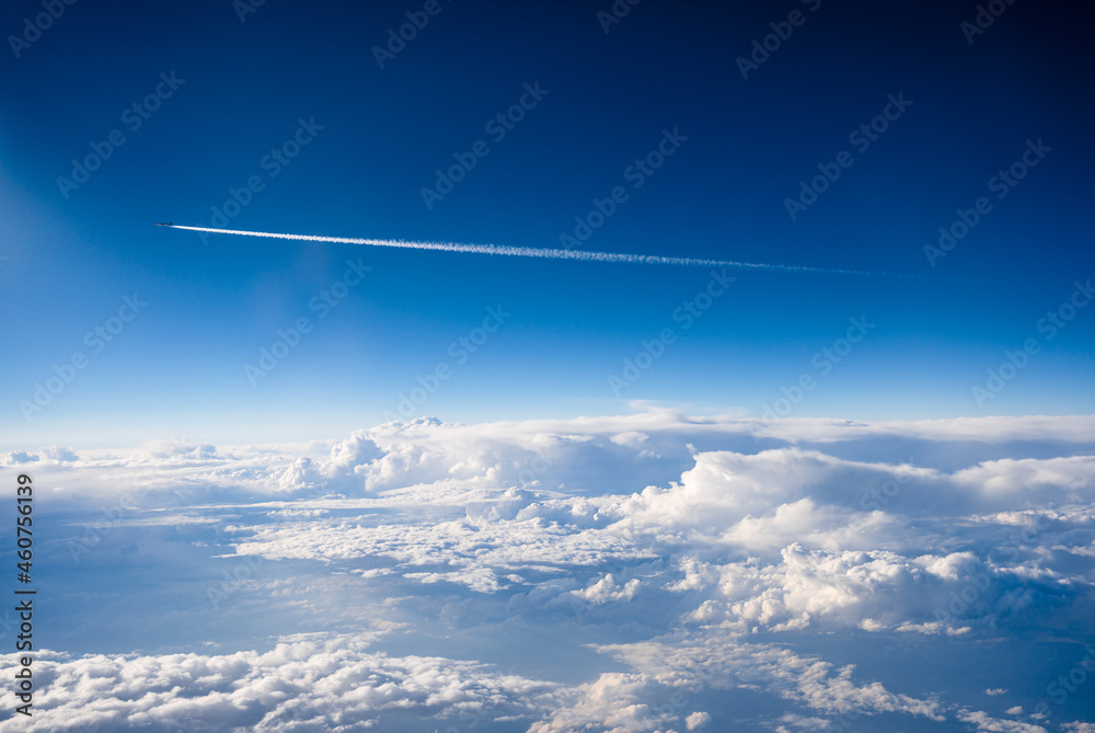 Commercial airplane flying over the clouds on a sunny day Commercial airplane flying over the clouds on a sunny day