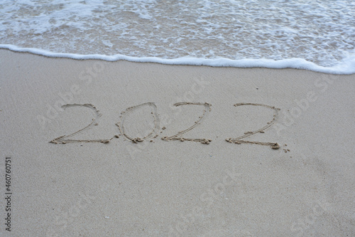 Written 2022 on the beach sand with soft wave.