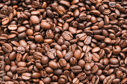 Coffee beans background. Brown roasted coffee beans. Many coffee beans. Coffee beans can be used as a background. Fresh roasted coffee beans.