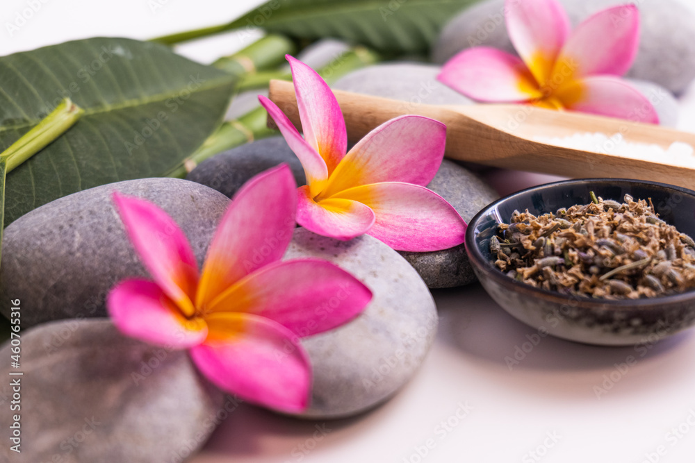 frangipani flowers as a spa concept with zen stones and small bowls