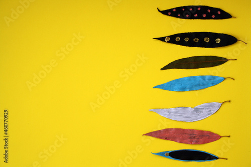 Hand-painted paint on dry autumn leaves. Children's art project. Painted leaves on a yellow background. Free Download Hand-painted paint on dry autumn leaves. Children's art project. Painted leaves on a yellow background. - GFXLoad