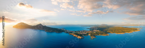 View from above, aerial shot, stunning panoramic view of Golfo Aranci during a beautiful sunrise. Golfo Aranci is a village that extends along a strip of land into turquoise sea. Sardinia, Italy. © Travel Wild