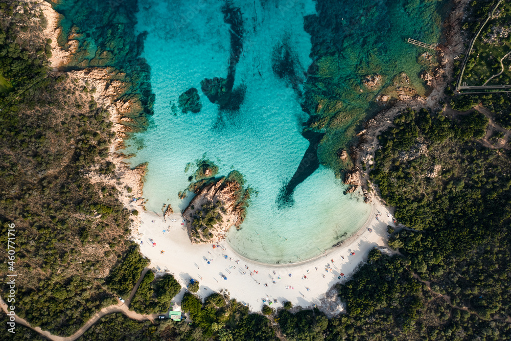 View from above, stunning aerial view of a green coast with the beautiful Prince Beach (Spiaggia del Principe) a white sand beach bathed by a turquoise water. Sardinia, Italy.