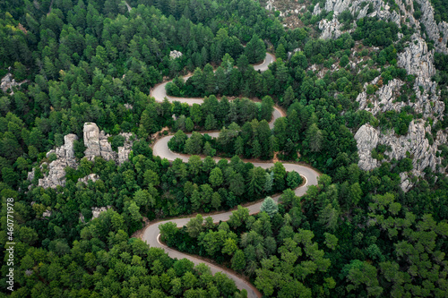 View from above, stunning aerial view of a serpentine road surrounded by green pine trees. Mount Limbara (Monte Limbara) Sardinia, Italy photo