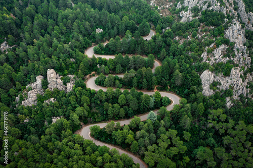 Photos View from above, stunning aerial view of a serpentine road surrounded by green pine trees
