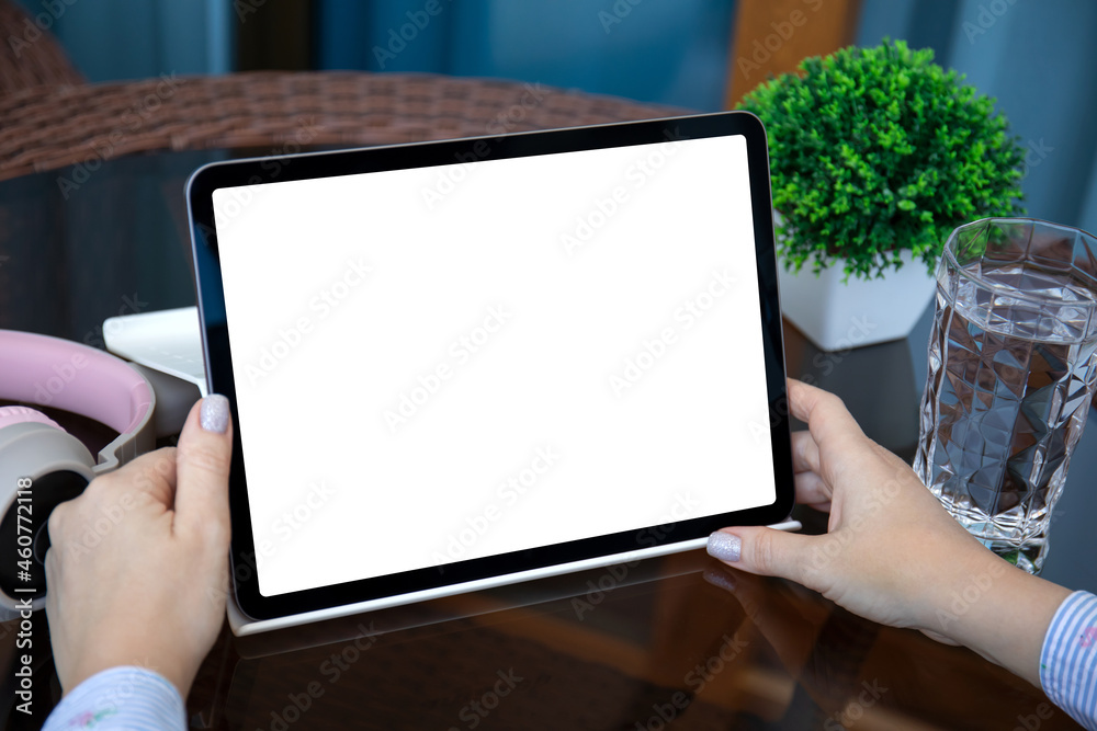 female hands holding computer tablet with isolated screen in room