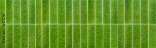 Panorama of light green glazed tiled wall pattern ans background seamless