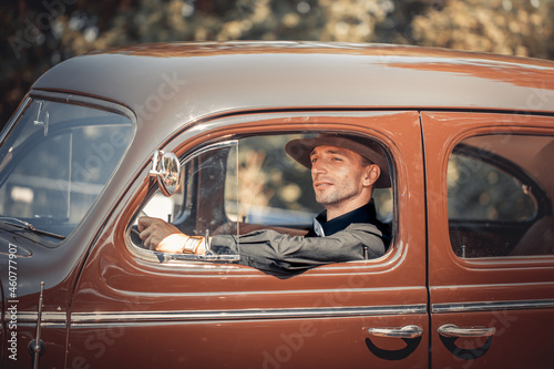 Young man in retro car