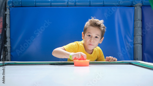 Canvas Print boy intently and enthusiastically play table hockey