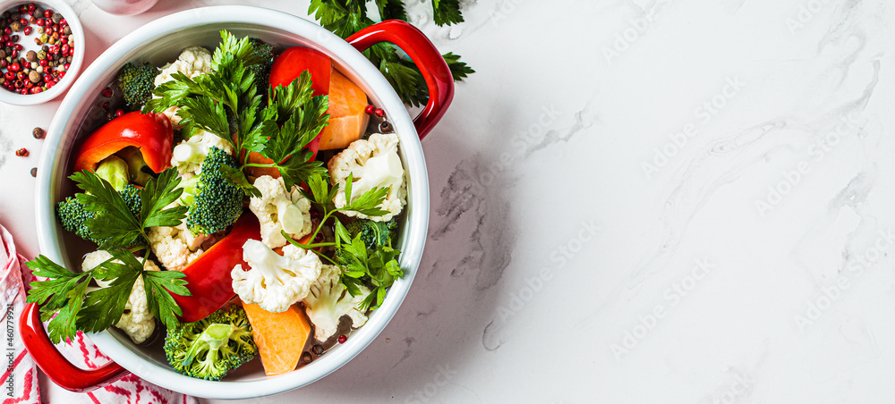 Vegetarian soup with broccoli, cauliflower, peppers and sweet potatoes in saucepan. Cooking healthy food concept. Vegetarian soup with broccoli, cauliflower, peppers and sweet potatoes in saucepan. Cooking healthy food concept.