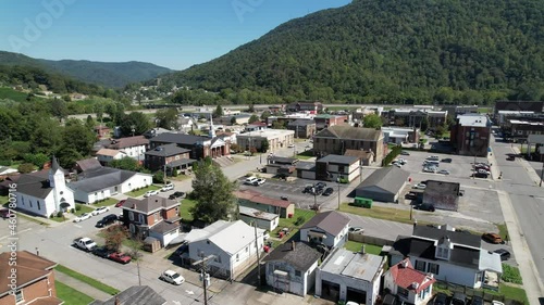 aerial push into pineville kentucky with church in foreground, small town america, hometown, small town usa, middle america in the suburbs photo