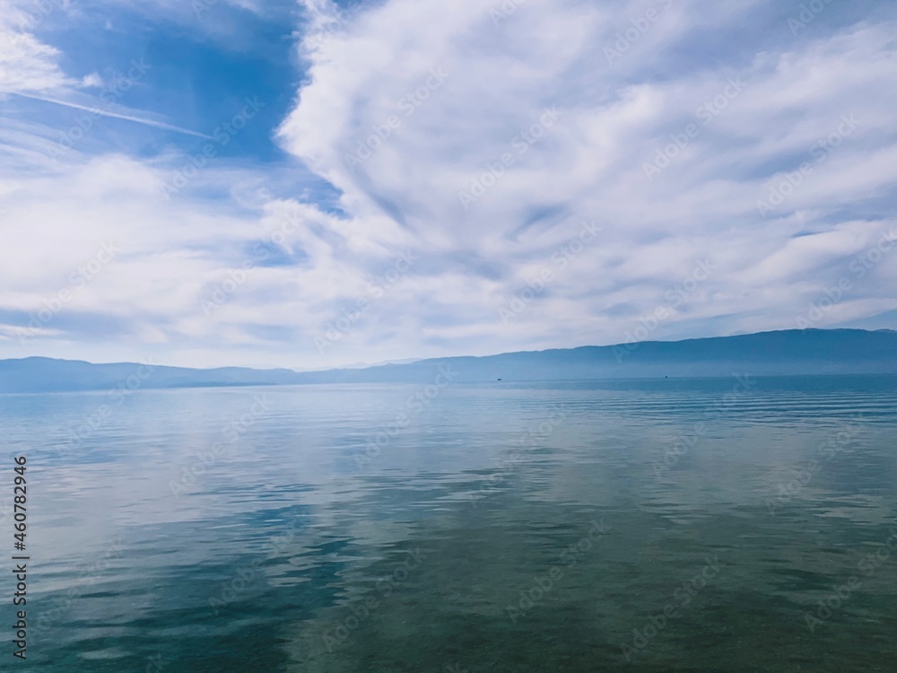 Amazing lake surface, transparent water, reflection, abstract sea background