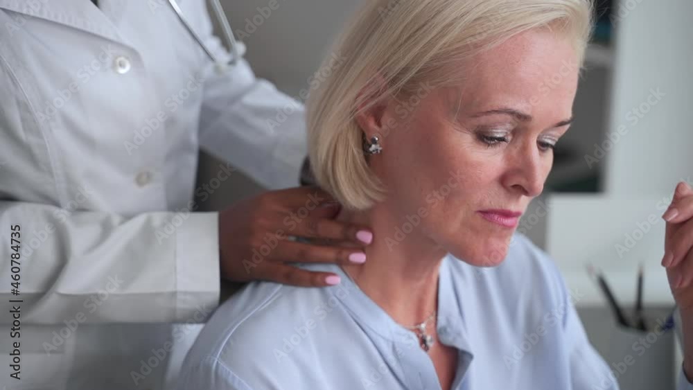 Doctor traumatologist appointment in clinic. Spbas Upset mature lady patient with blonde haircut undergoes painful shoulder examining in hospital closeup Doctor traumatologist appointment in clinic. Spbas Upset mature lady patient with blonde haircut undergoes painful shoulder examining in hospital closeup