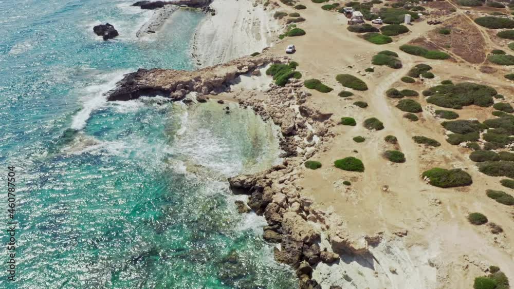 Aerial view of the seascape. The waves of the blue ocean crash against the rocks. Beautiful Mediterranean nature in Cyprus. Aerial view of the seascape. The waves of the blue ocean crash against the rocks. Beautiful Mediterranean nature in Cyprus.