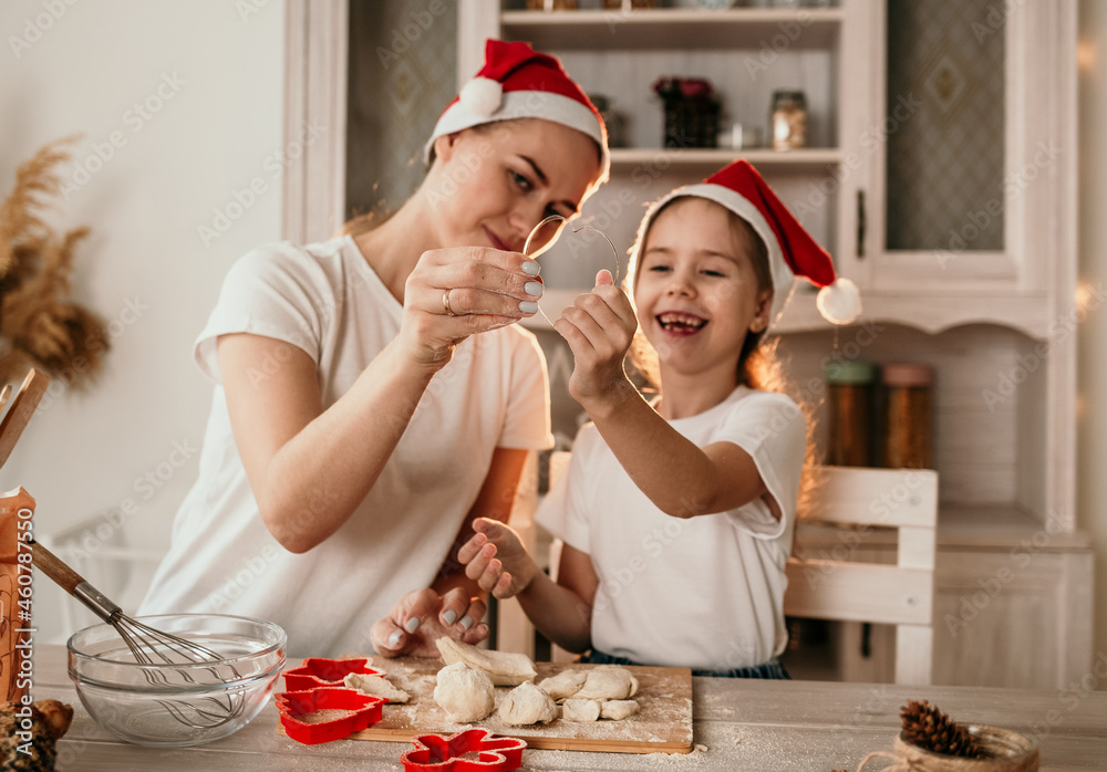 close-up of mom and daughter holding a baking dish on a festive background