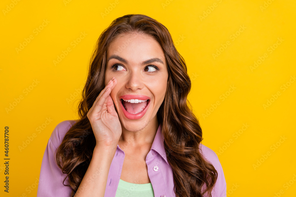 Photo of young excited happy woman look empty space tell announce news secret smile isolated on yellow color background Photo of young excited happy woman look empty space tell announce news secret smile isolated on yellow color background