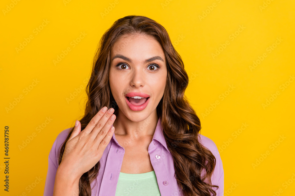 Portrait of attractive amazed cheerful wavy-haired girl good mood reaction isolated over bright yellow color background Portrait of attractive amazed cheerful wavy-haired girl good mood reaction isolated over bright yellow color background